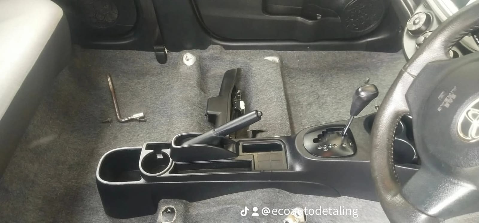 Vehicle interior with seats removed for carpet and centre console cleaning