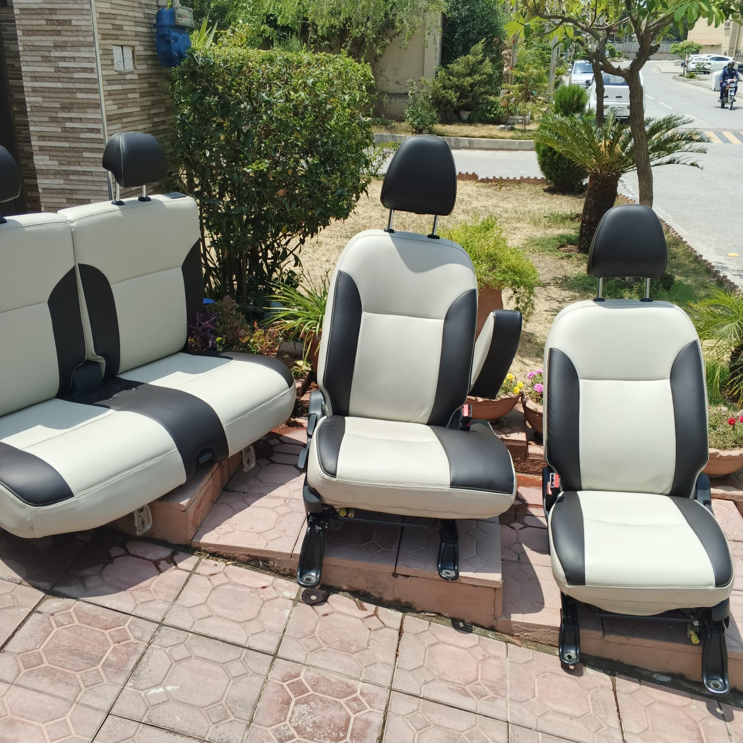 Removed two-tone vehicle seats arranged outside for upholstery care